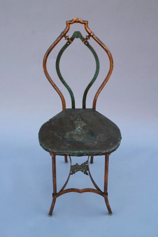 Lovely little Spanish Revival iron chair with original polychromed finish and hand-painted leather seat