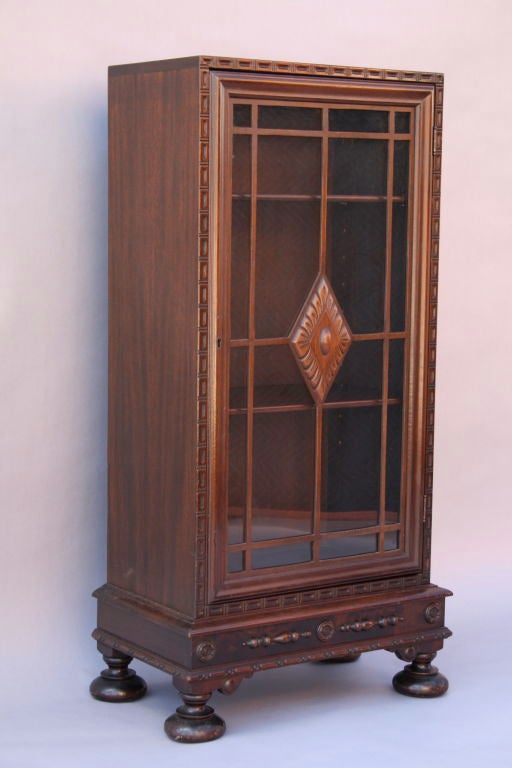 Narrow glass front cabinet with two adjustable shelves.  Very difficult to find piece.