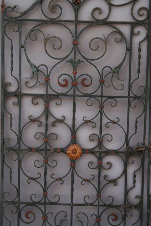 Exceptional 1920's wrought iron gate with original paint and very detailed iron work. It is a bigger version of another pair we also have listed- please check our listing.
