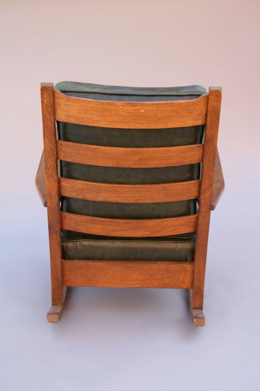 Classic Mission period rocker finely crafted by Gustav Stickley.   Open arms with corbeled front post.