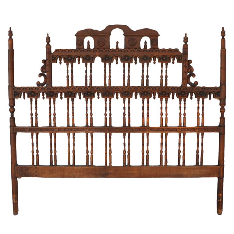 Beautifully carved walnut headboard with turned spindles.