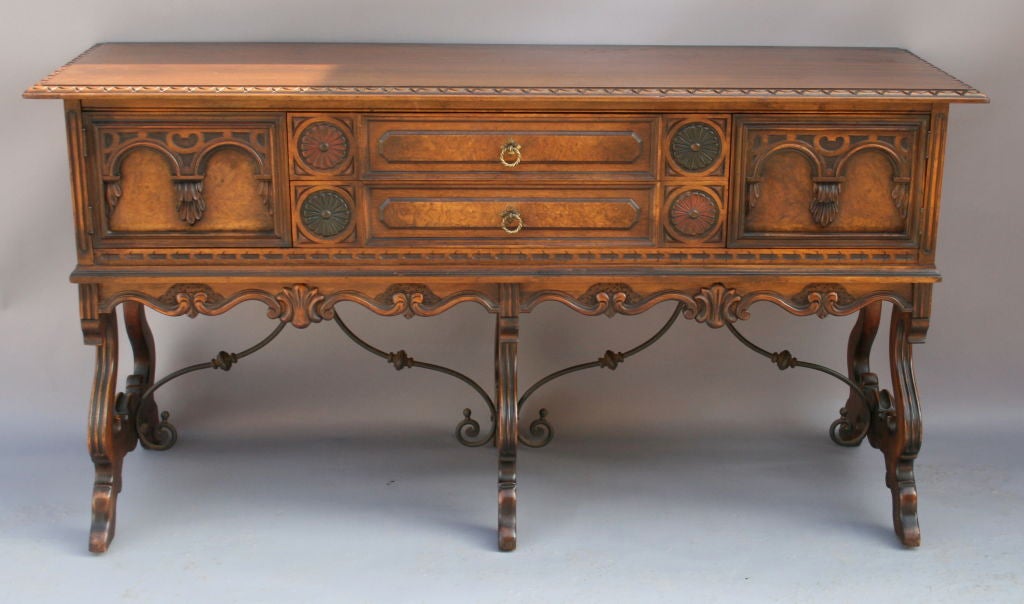 Beautifully crafted 1920's sideboard by Berkey and Gay with original polychrome detailing to finish and double wrought iron stretchers