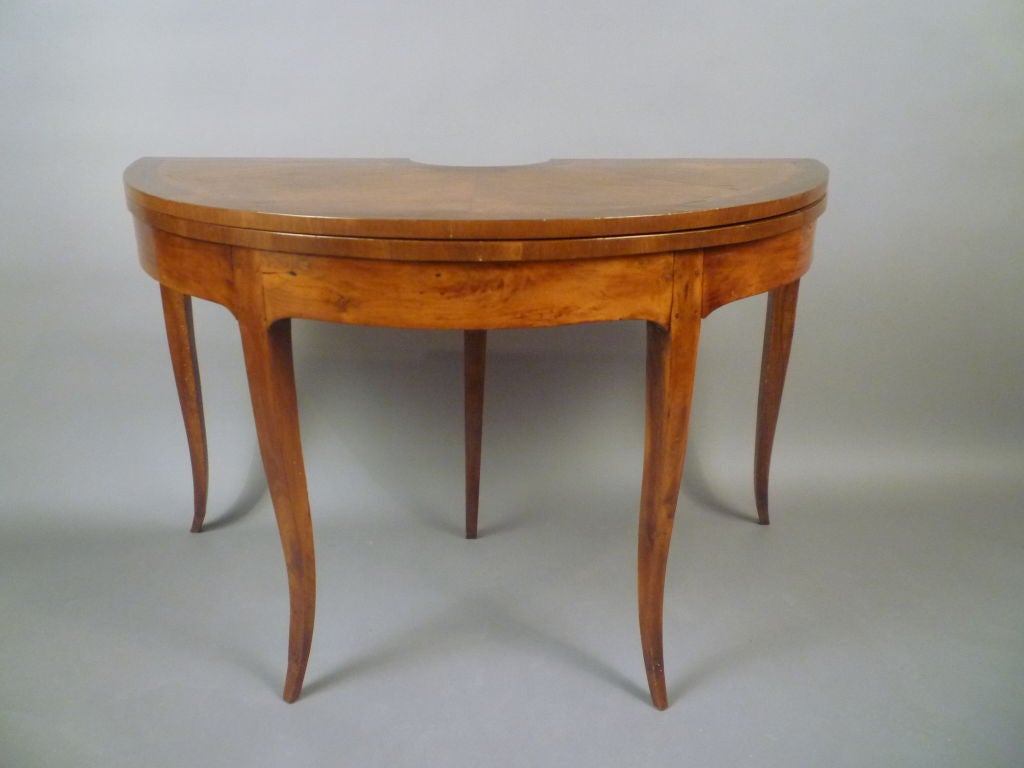 A German Parquetry Mahogany Card Table, the foldover crossbanded top above a plain apron and 4 square cabriole legs,leather top.