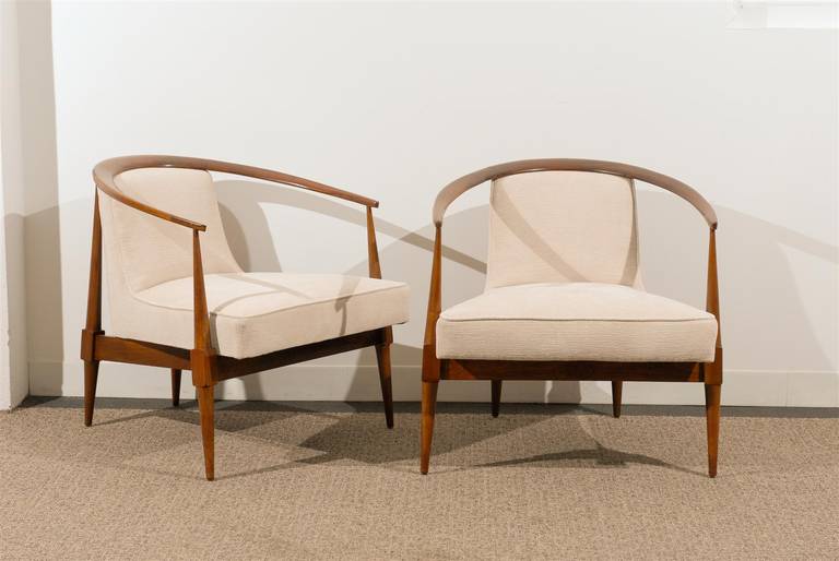 A Beautifully conceived pair of Modern lounge/club chairs, circa 1950's.  Fashioned from rich, warm Walnut with Exquisite detail.  Wonderful scale and form, these chairs make a Stunning Statement !  While the pieces are unmarked, this design is