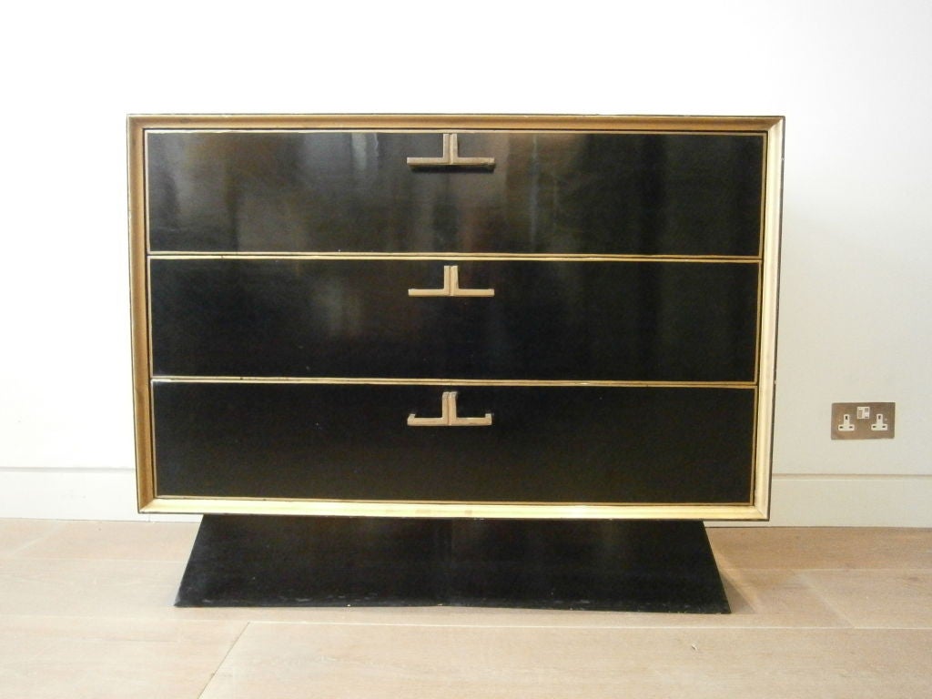 3-drawer chest of drawers black lacquer with gold detailing and bronze handles on a shaped plinth base