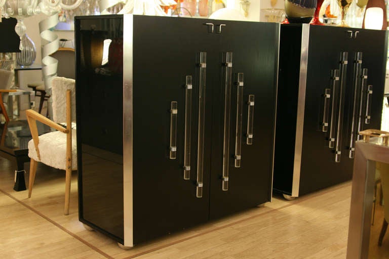 A pair of tall black lacquer cabinets/bar, one internal shelving each with perspex details. Made in Italy ca. 1970s