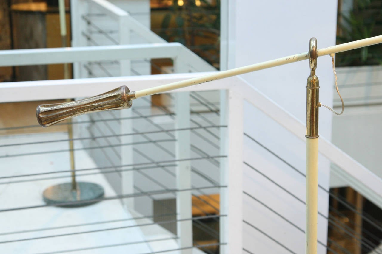 A rare floor lamp by Angelo Lelli, articulating arm and shade on marble base with brass details. Made in Italy.
