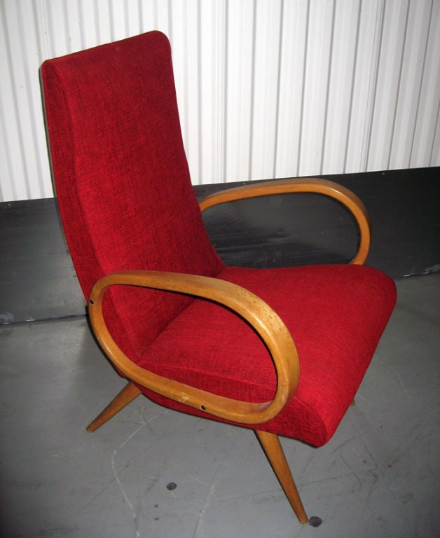 A pair of curvilinear armchairs.Wooden frame,honey blond bentwood arms and tapered legs upholstered in a red woven velvet.Hand Made