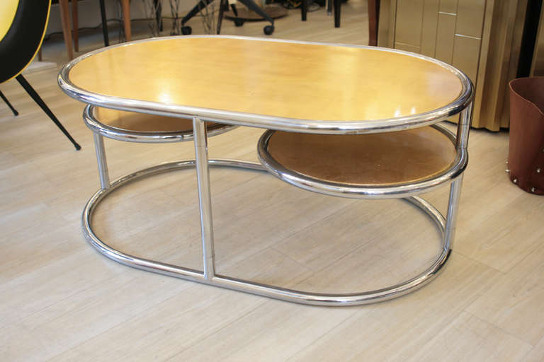 A beautiful occasional coffee table, chromed tubular structure with oval top gold leaf on wood and two round fordable sides. Italian design by Levans 

Extended: 180cm