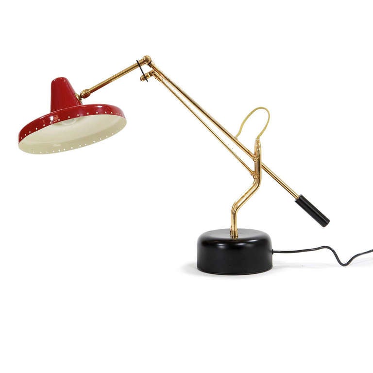 Red enameled articulated shade and adjustable heights, brass arms on a black enameled base. Made in Italy.