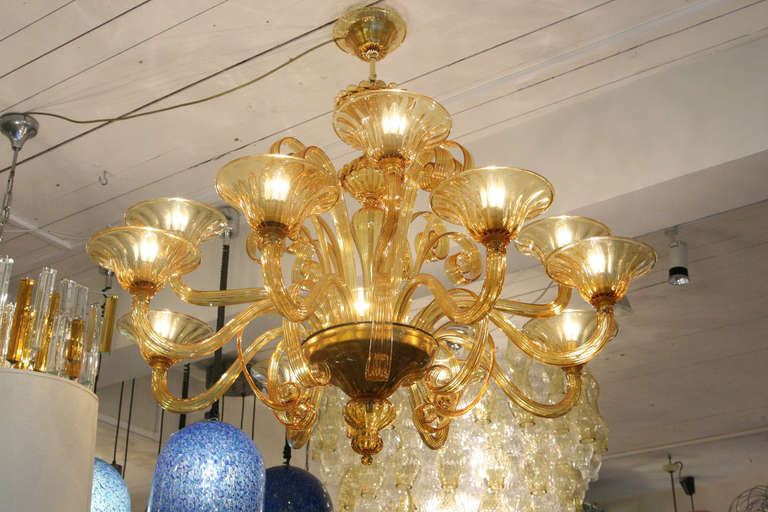 A 12 arms Venetian chandelier, hand blown amber color glass structure design by Cenedese