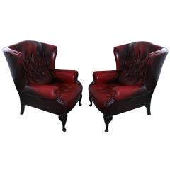 A pair of leather wing armchairs Vintage A pair of leather wing armchairs