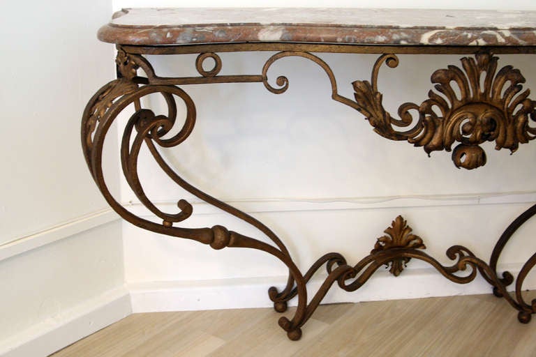 A beautiful gilt wrought iron console table with marble told. French school of Poillerat. 1940s