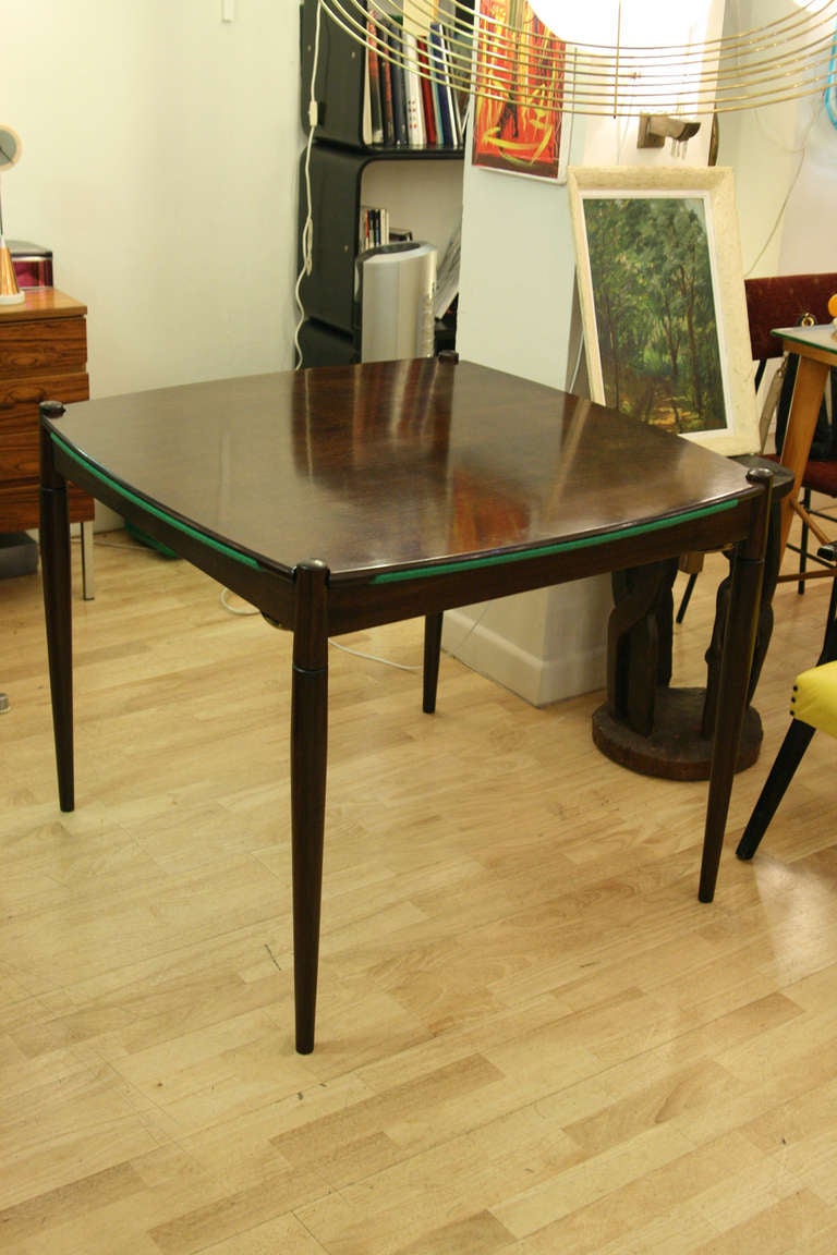 Two face table as a poker table or a dining table. Ebony wood green felt top on one side. Gio Ponti design. ca.1950s