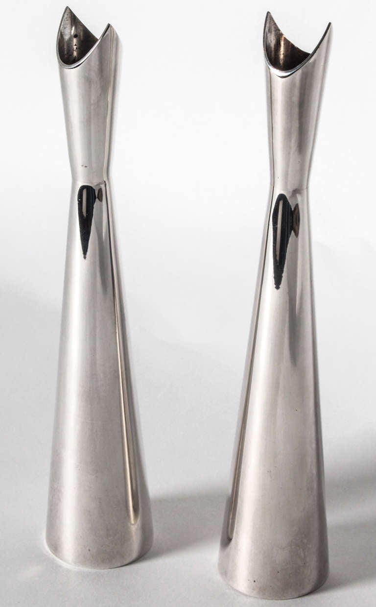 Pair of Lino Sabattini "Cardinale" silver plated brass vases designed in 1950s. These slender double conical shaped pieces are meant to hold a single flower. Each are marked Christofle France.

About the artist:
"The versatile and