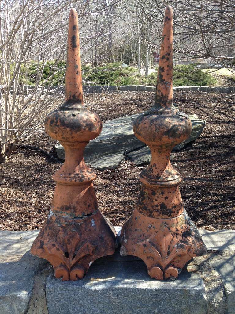 These tall 19th century finials originally adorned the rooftop of an important house in Lemans, France and sport an enviable weathered surface and fleur-de-lys decoration. In excellent antique condition, the finials are mortared to their bases, but