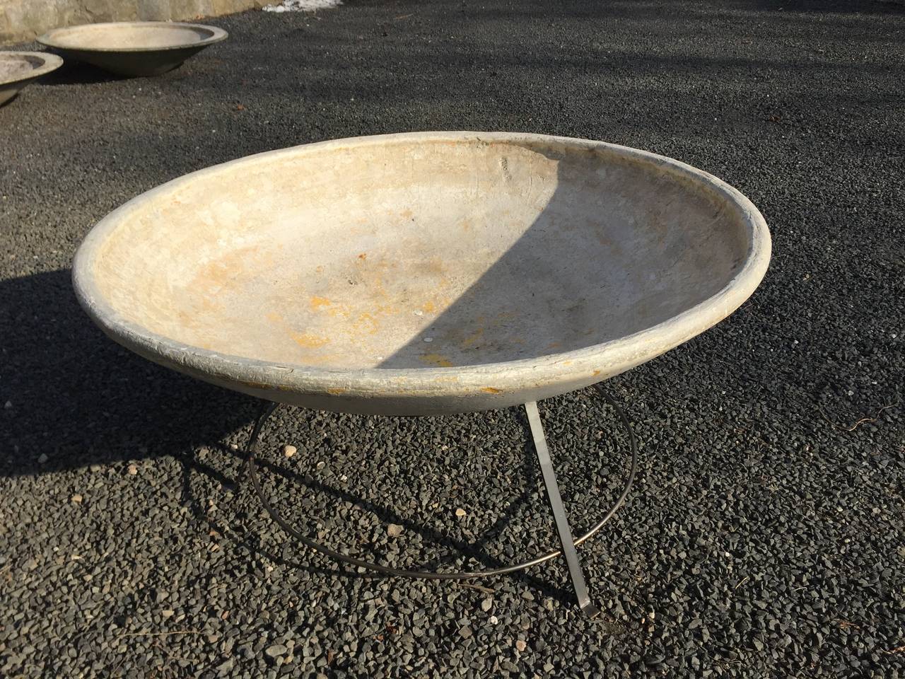 This rare 4' diameter beauty was designed by Willy Guhl for Eternit and dates to the 1960s. In fabulous original surface and perfect condition, it has a steel stand that dates to the period, but may not be original. The planter is magnificent potted