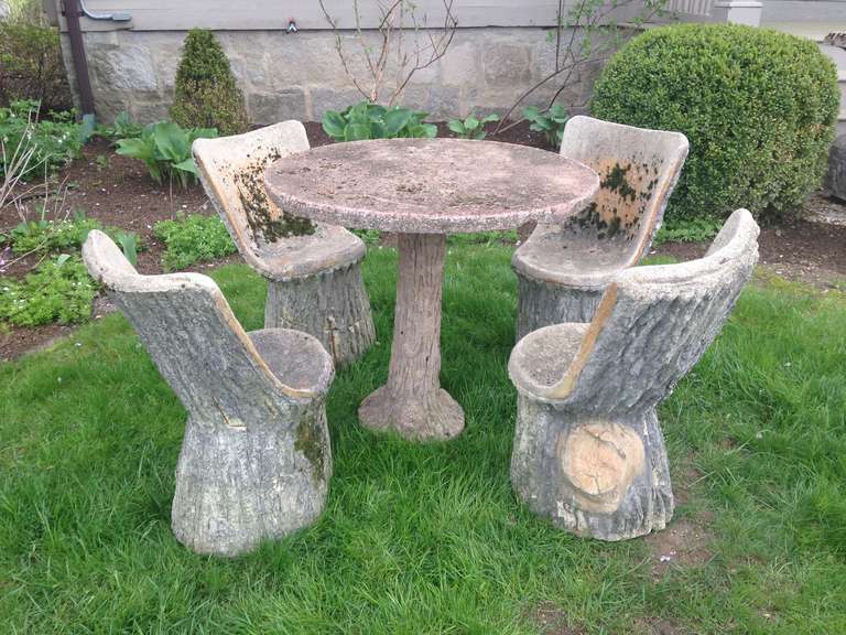 Impossible to find these days, this set of authentic French faux bois bucket chairs is the perfect complement for your outside dining space. Very heavy and well-constructed, they have lots of moss and a beautifully-weathered surface. As is normal