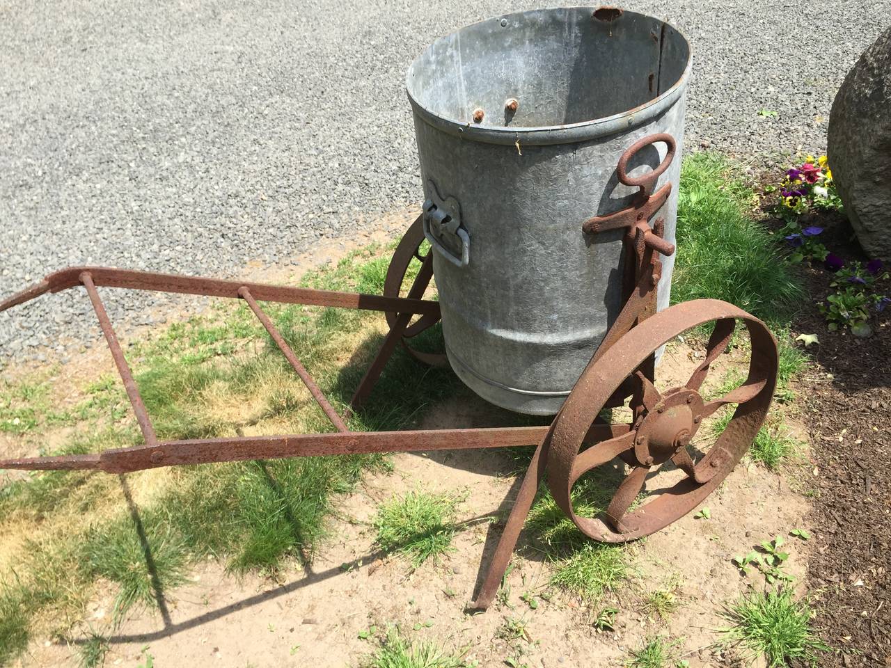 This early 20th century English water barrow is simply wonderful! It was originally parked under the eaves of a house, left to fill with rainwater, and then carted around the property to water the gardens. This one has a lovely bucket and a