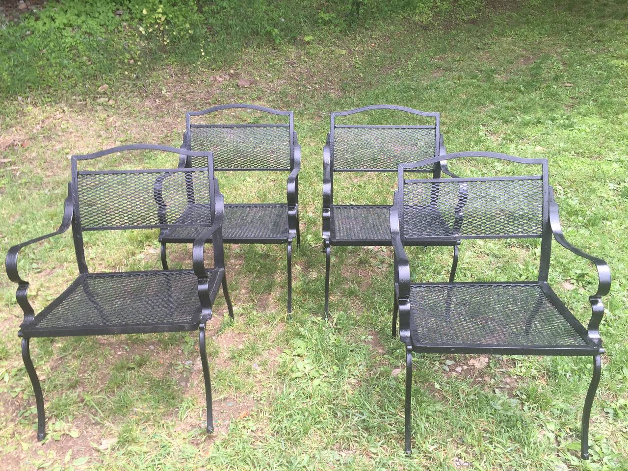 These Mid-Century Modern wrought iron garden chairs are solidly made in the style of Paul Follet and sport new black paint. Commodious seats make for hours of comfortable sitting on your terrace or around a dining table in the garden.