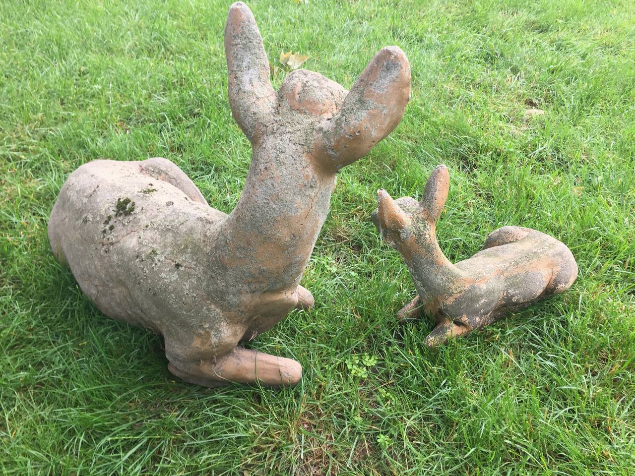 Simply charming! These beautifully-weathered figures of a doe with her fawn have loads of lichen, a bit of moss, and traces of original tan paint. In perfect condition, they will make a welcoming vignette to your farm or country house.
The doe