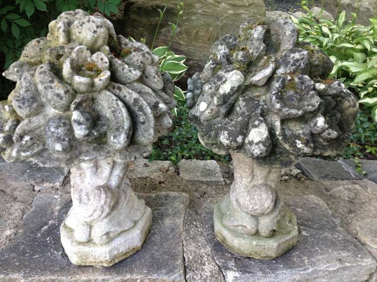 This beautiful pair of cast stone fruit and flower baskets has a superbly weathered surface with lots of greening, lichen and moss.  Featuring unusual octagonal cornucopia bases, they are substantial and would be perfect atop a pair of stone gate