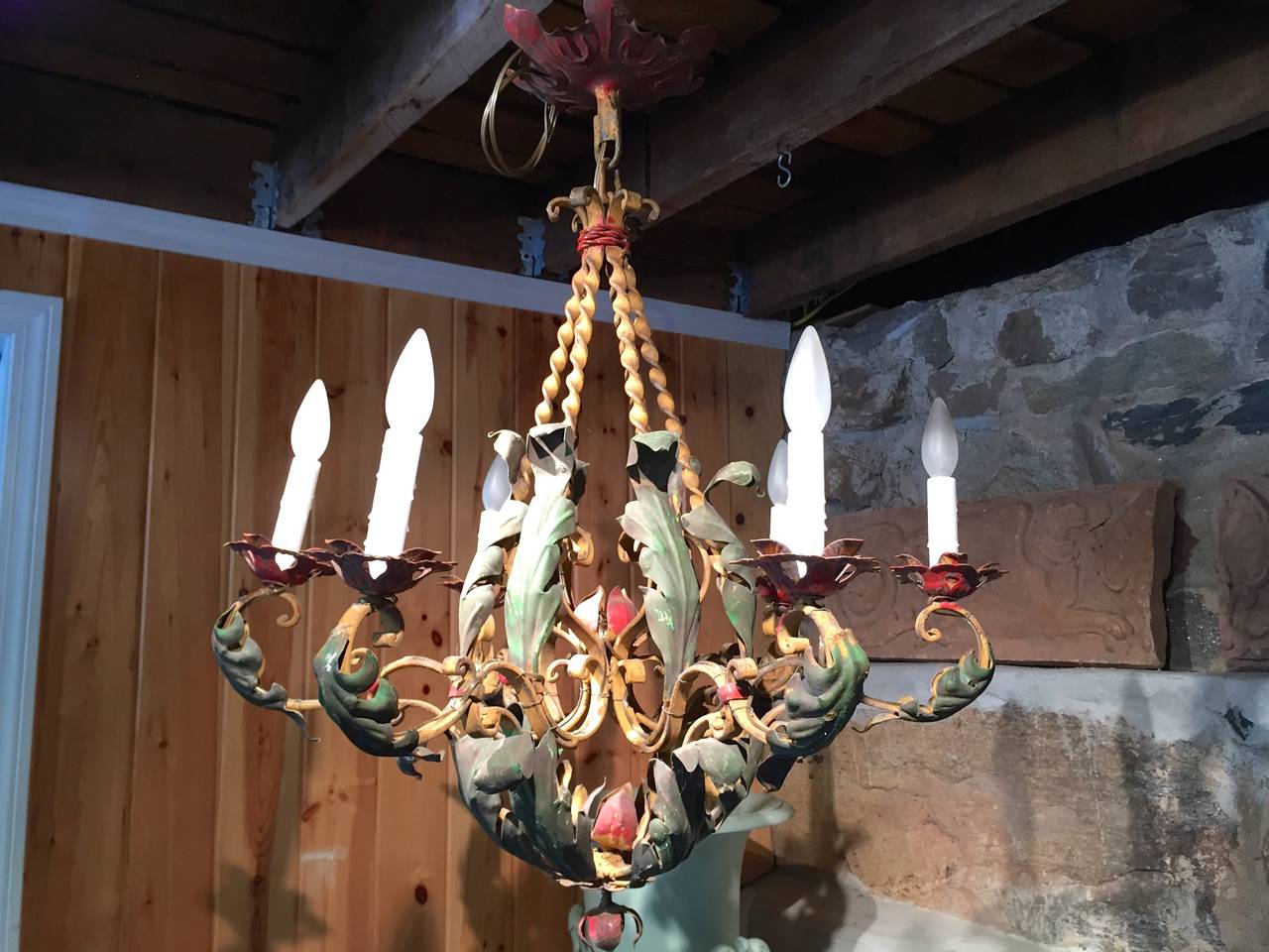 You either love this one or hate it. We fall into the former camp. Delightfully Rococo, this lovely-sized six-light chandelier features its original dark green, red and ochre paint, with acanthus leaf motif and pierced bobeches. We have kept its