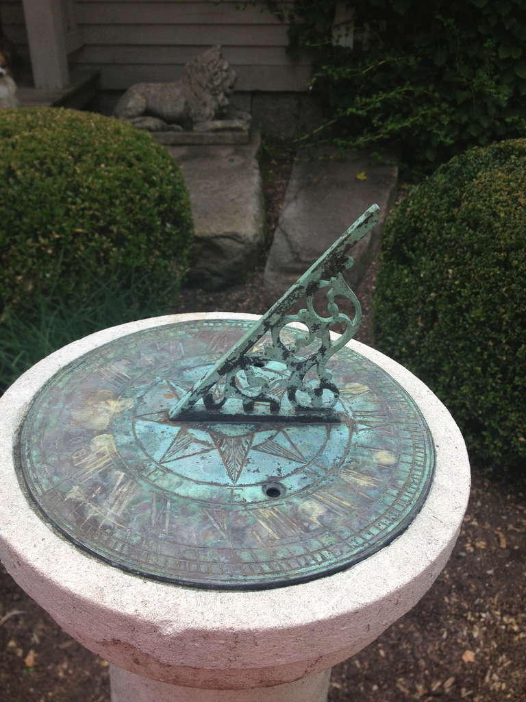 This classically-elegant carved Portland Stone sundial features its original naturally-patinated brass plate and elaborate gnomon (pointer).  Heavily lichened and in wonderful condition, it will make the perfect addition to the center of your rose