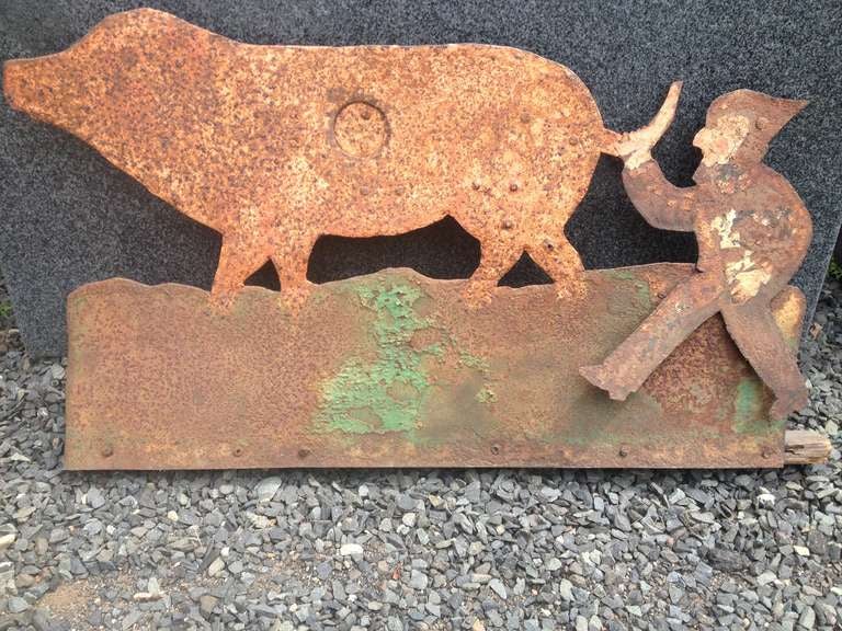 What a fabulous piece of folk art!  Hand-crafted from sheet iron and with traces of its original paint, this whimsical piece was once a carnival shooting target.  When you hit the bulls eye, the elf pulls off the pig's tail.  A great conversation