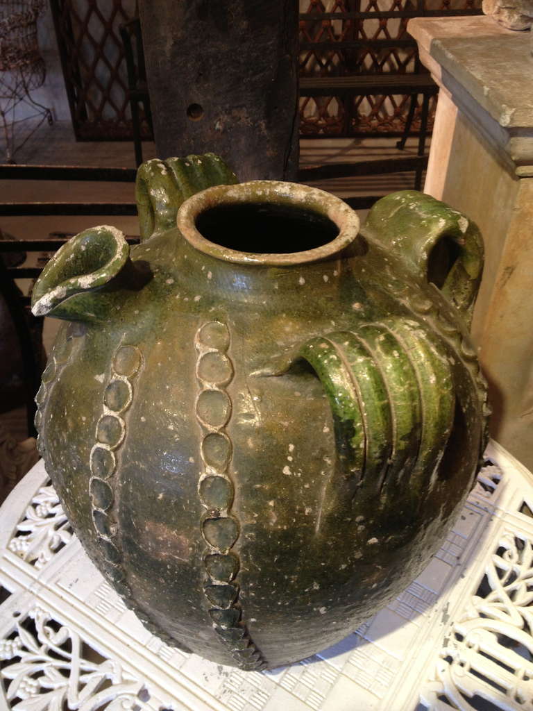 This unusual form of water pitcher is native to the Southwest of France and this beauty dates to the mid-late 18th century. Handmade with a beautiful dark-green glaze and with a charming vertical thumbprint chain motif, it is fully functional and