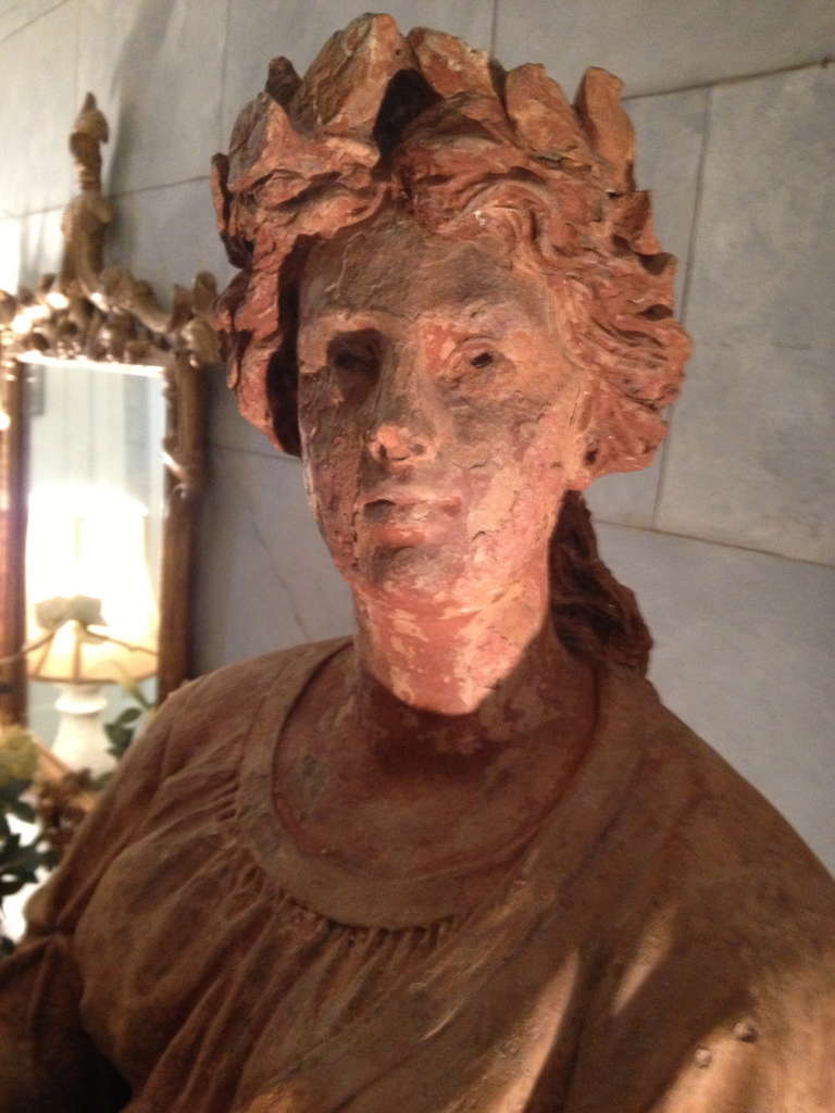 It is rare to find a life-size terracotta statue of such age which, other than missing its hands, is in remarkably good condition. Stamped on the base, the maker is illegible, but one can make out that she originated in Milan. This beauty is