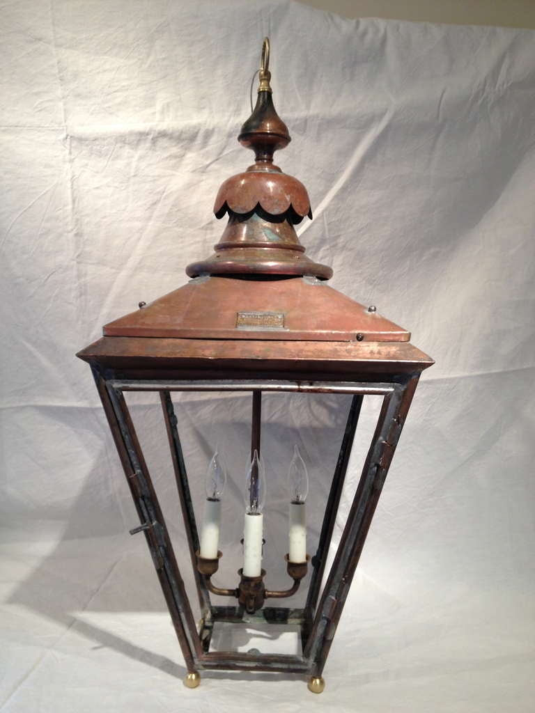 Signed by their maker (W. Parkinson & Co. of Birmingham & London), and dating to around 1910, this elegant pair of copper gas lanterns has been fully restored and electrified.  We have added custom brass lighting clusters (total 300 W/lantern) and