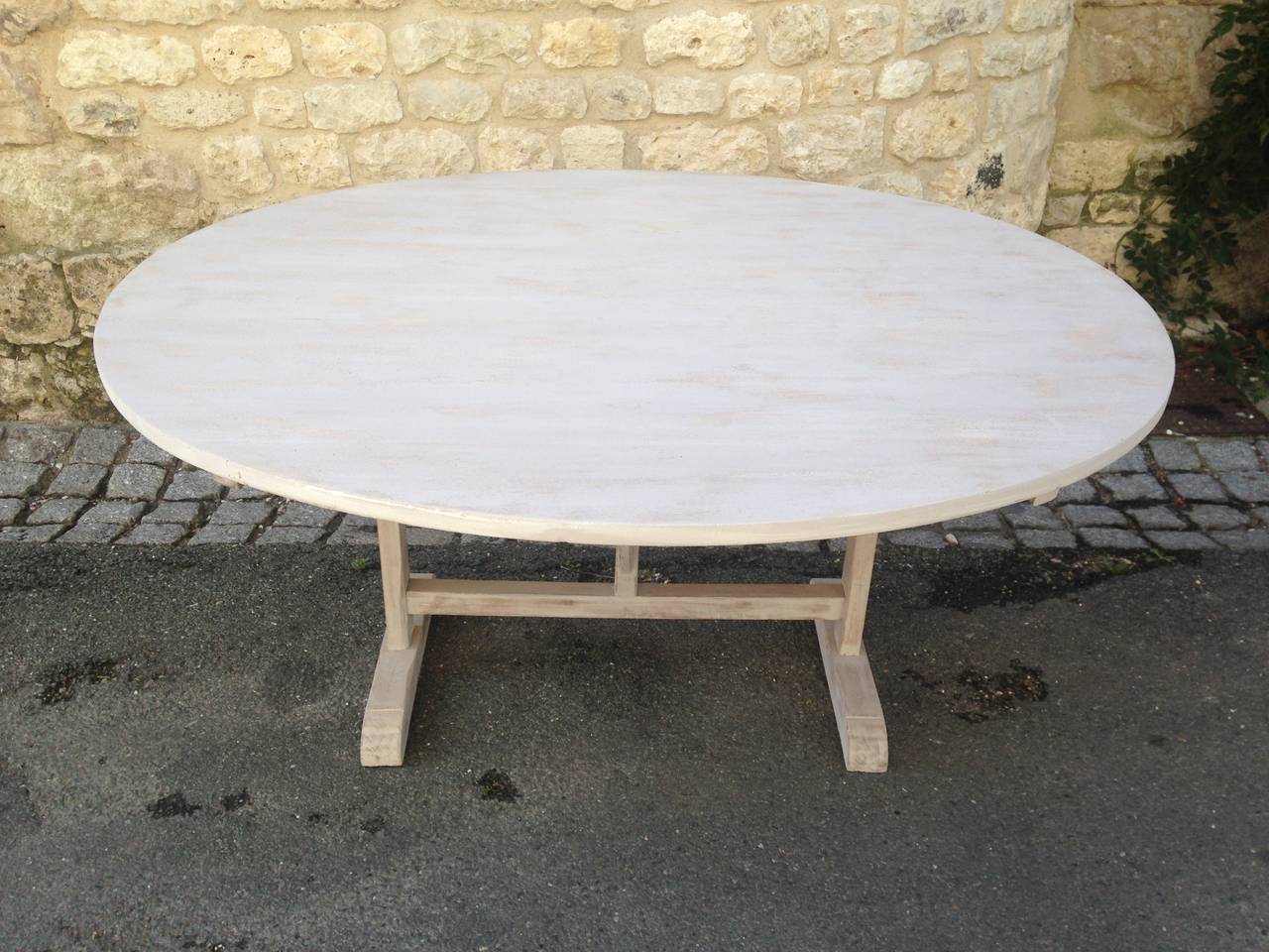 This stunning vendange (wine-tasting) table hails from the southwest of France and dates to the late 19th century. The original poplar top and oak base have been beautifully-refinished in a translucent pale grey milk paint that has been coated with