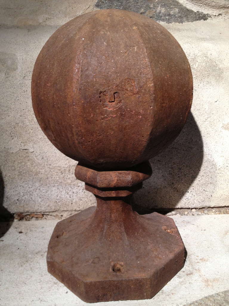 We love the rare octagonal ball form of these heavy cast iron finials. Beautifully rusted to a warm brown, they can be left as-is or sandblasted and repainted to your specifications. Great atop a stone wall or pathway flanking the entrance to your