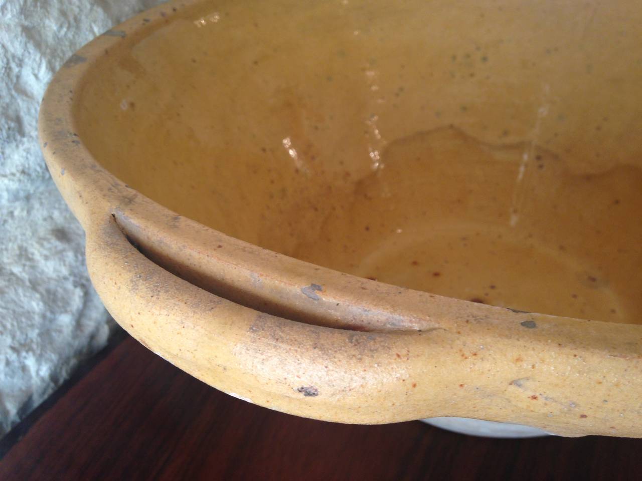 We found this wonderful handmade, glazed terracotta dairy bowl near Montauban in the Southwest of France, where its original use was to collect milk for the making of cheese. Beautiful overflowing with green apples or as an unusual container for a