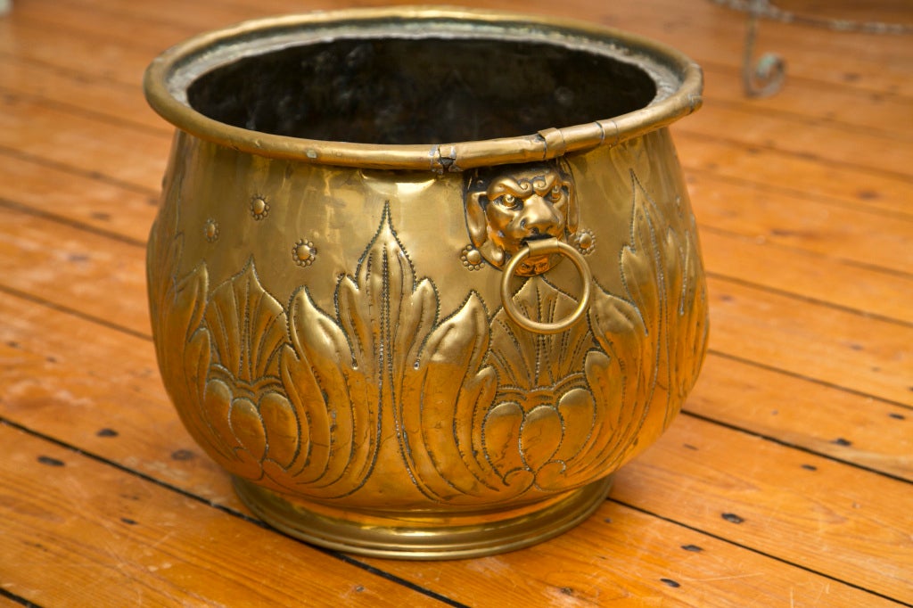 Dating to the 1840s, this is a stunning handcrafted piece with strong repoussé work, lion mask rings and a hand-rolled rim. This planter is in wonderful condition and emits a soft glow, but you can easily bring back to a brilliant finish. Celebrate