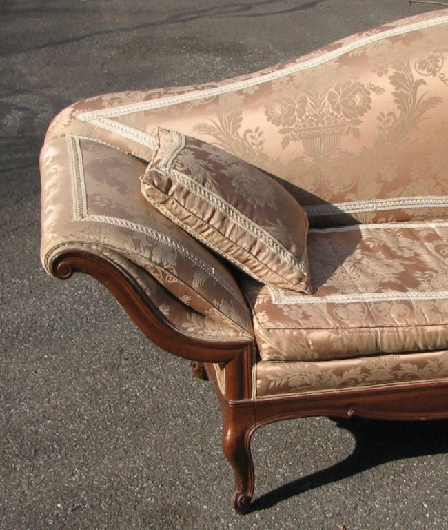 Fine Italian 18th century style sofa Piedmontese of substantial size, with upholstered serpentine back, padded serpentine outscrolled arms with scrolled terminals, loose cushion seat, and molded walnut frame raised on cabriole legs ending in