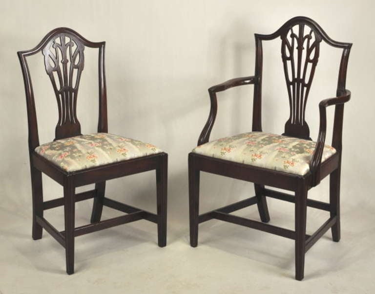 Exceptionally fine and rare set of ten Hepplewhite transitional mahogany dining chairs, with arched crest rail and flaring stiles, with pierced cutout splat in prince of wales design, with molded front legs and 