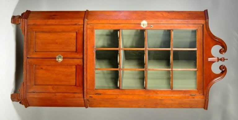 Fine federal cherrywood two part corner cupboard, with scrolled molded top with central urn finial, above a rectangular 13 lite mullioned door, set on a base section with two inset paneled doors and raised on shaped ogee bracket feet. Connecticut,