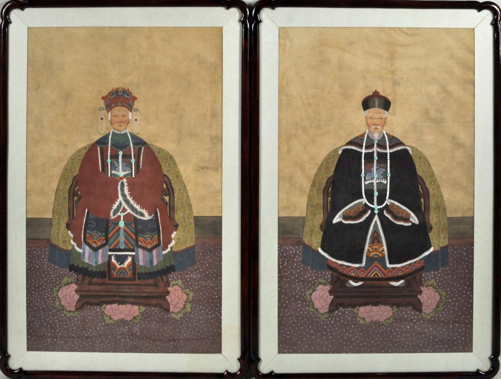 Very nice pair of framed Oriental ancestral portraits of man and woman, on silk in good condition with fine color, framed in notch corner wooden Asian style frames. Probably Chinese, late 19th century.