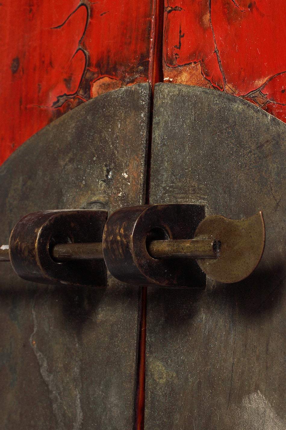 A Chinese red lacquered armoire with iron hardware from the 1800s. This large Chinese armoire was made with red lacquered wood and iron hardware. The tall rectangular shape is adorned by molding on its top. The four legs supporting this piece are