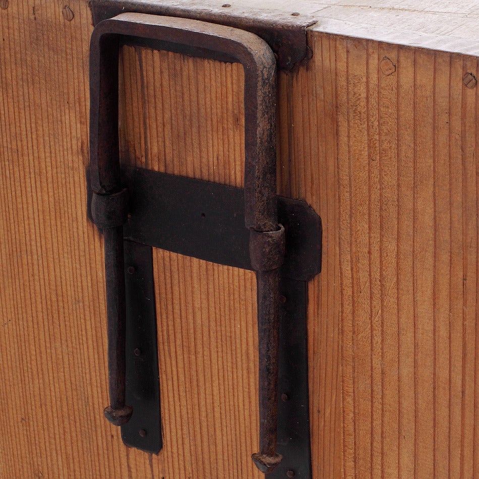 An antique merchant’s chest with iron hardware from 19th century Japan. This late 1800s merchant’s chest comes from Japan, where it was made with Kiri wood and incised iron hardware. The chest features a full width top drawer, a bottom row with one