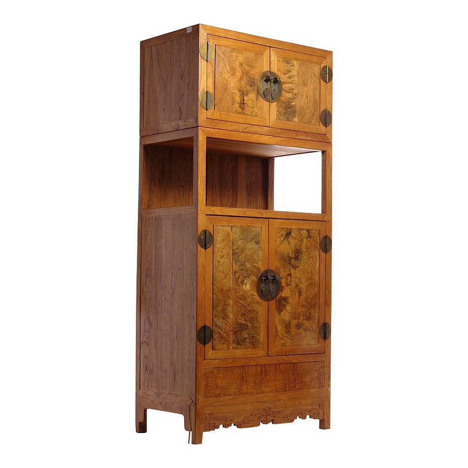 A Chinese 20th century carved burl wood cabinet with two sections and four doors. This Chinese two section cabinet was made with burl wood showcasing an unusual patina. The cabinet displays an uncommon shape for Chinese furniture with a two