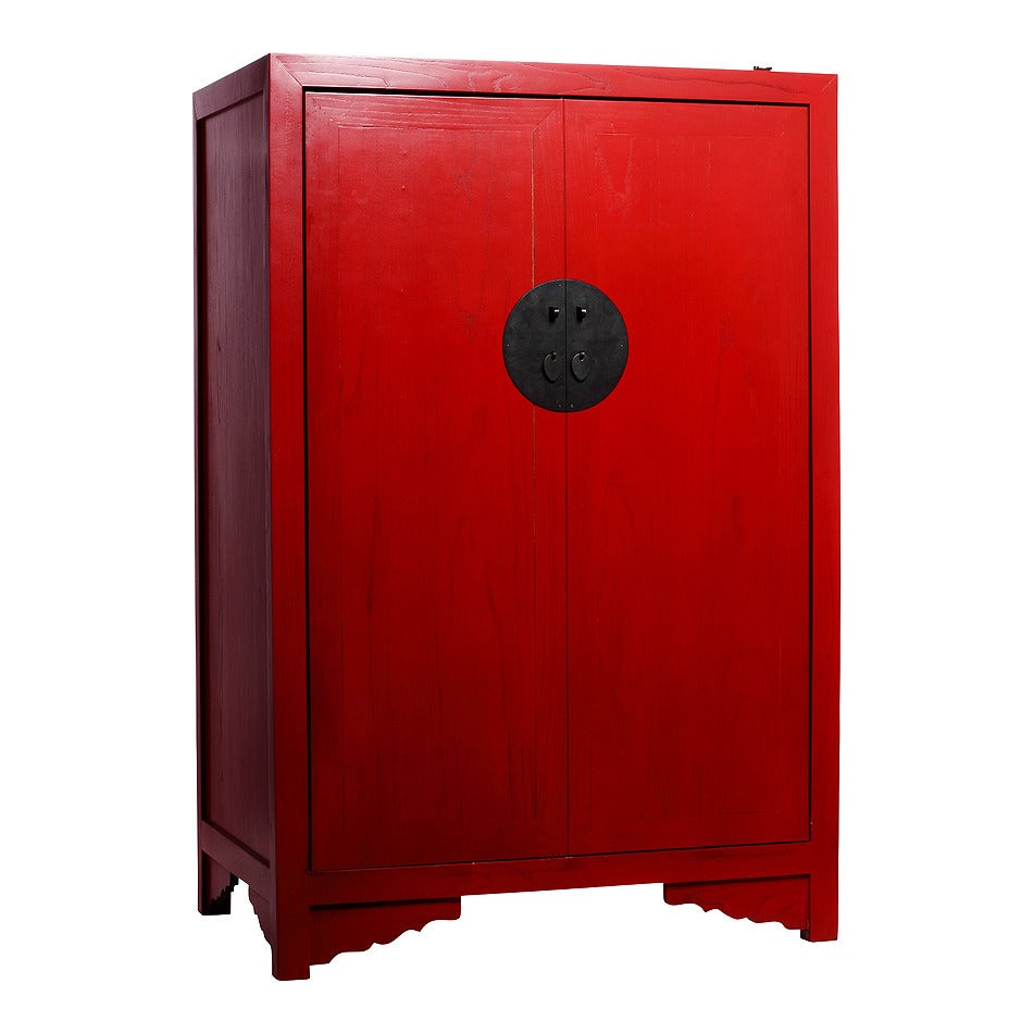 Chinese antique style red lacquered liquor cabinet from the late 20th century. This liquor cabinet was made in an antique style with red lacquered wood in China. The cabinet adopts a refined rectangular shape adorned only by two carved details on