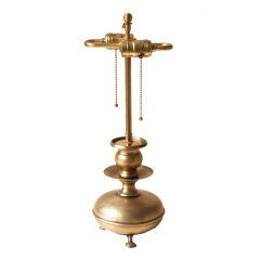 An unusual small baroque brass candlestick lamp.