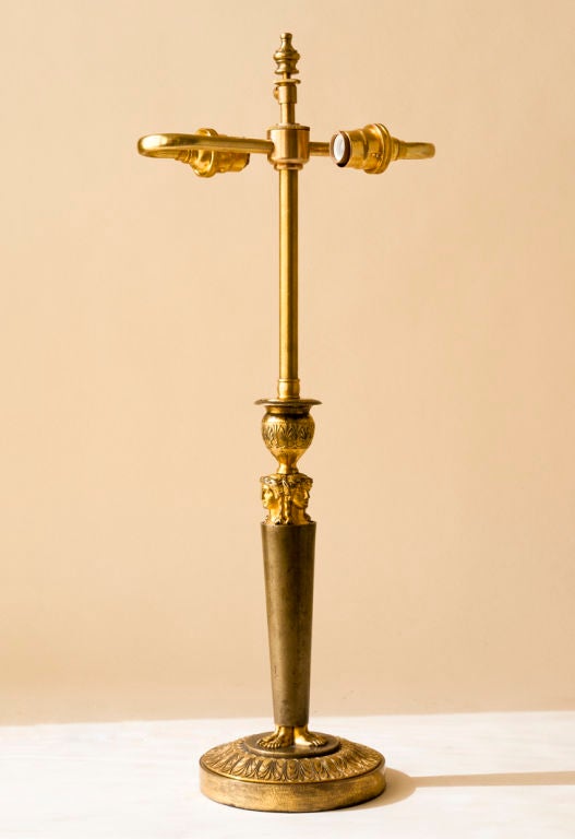 A French Empire period figural patinated and gilt bronze candlestick, wired as a lamp, French early 19th century (by Claude Galle not signed the same model as delivered to Chateau Fontainbleau in 1804)<br />
Diameter of base-5