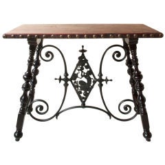 Renaissance style table, metal cross support with Pan figure