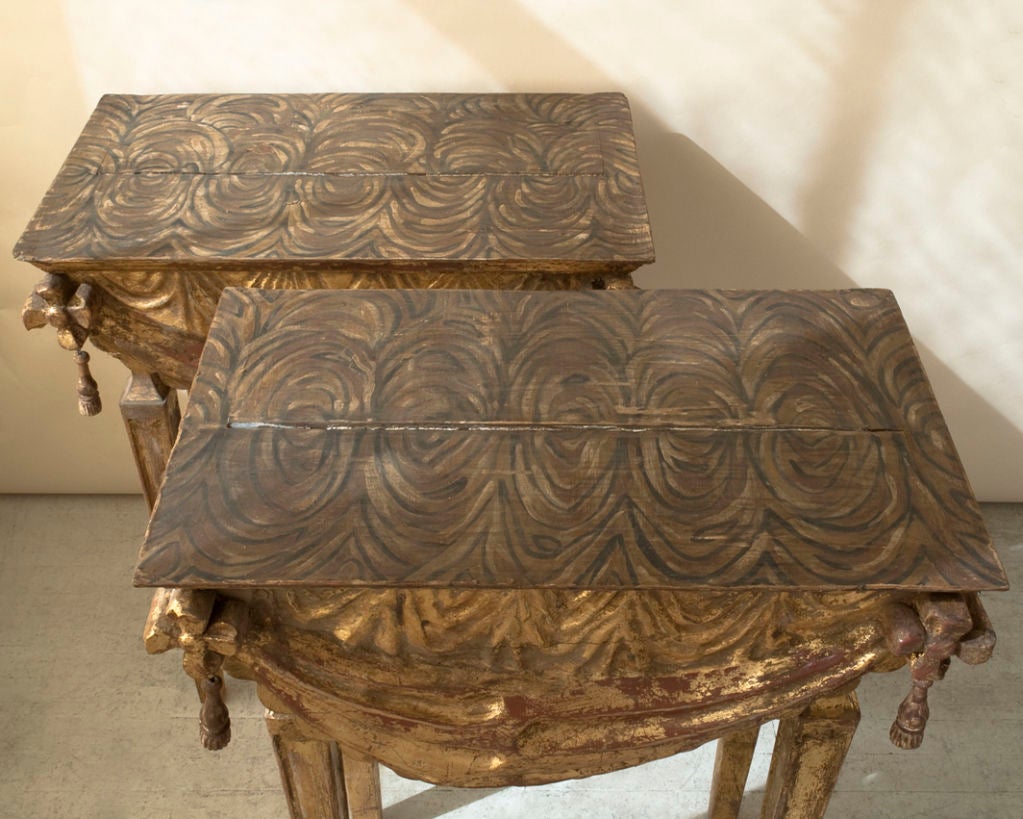 A paire of gilt and carved wood Italian consoles, draped fabric motif aprons, square tapering legs, 20th century
