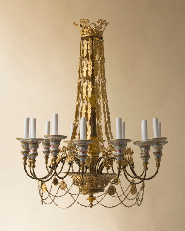 A fine and rare Napoleon III period chandelier, patinated and gilt bronze with Sevres porcelain candle cups, a draped bronze chain with a central shaft, with a fine pierced bronze basket, 14 arms with draped chains, French, c.1870, wired for