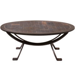 An unusual small steel and slate oval coffee table